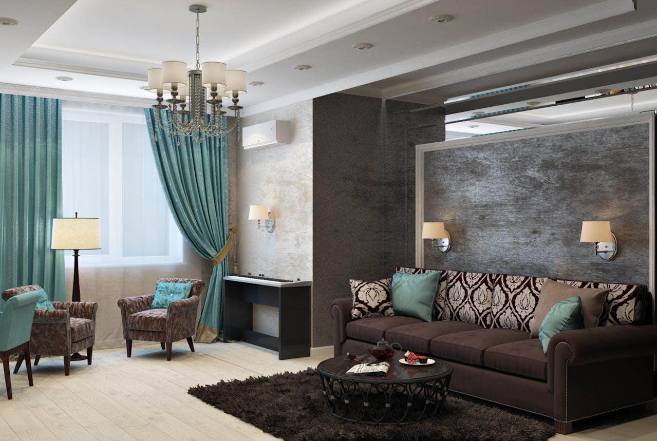 Blog 2 A modern living room with a brown sofa and two armchairs around a coffee table on a dark shaggy rug. A large window with teal curtains, a floor lamp, textured accent walls with sconces, a chandelier, light wood flooring, and a black console table against the wall.