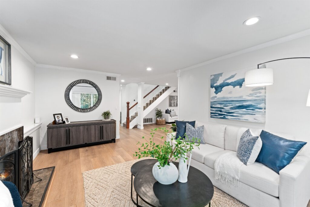 Home Staging Tips: Expert Strategies to Help Your Home Sell Faster 1 A cozy living room adorned with white furniture and blue accents, enhancing the overall decor, Home Staging Tips