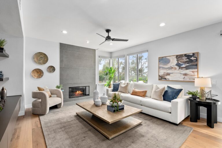 A bright living room equipped with a fireplace and sliding glass doors, creating an inviting atmosphere.