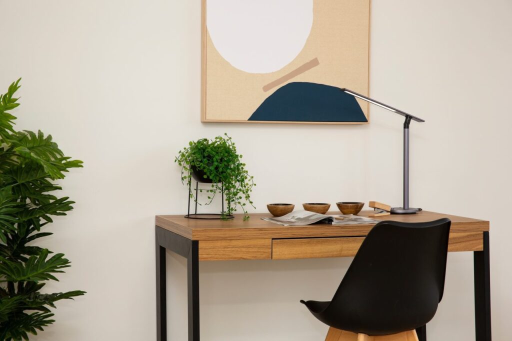 Home Staging Services for Realtors: A Powerful Listing Advantage 1 A desk featuring a lamp and a small potted plant, creating a cozy workspace atmosphere, Home Staging Services For Realtors